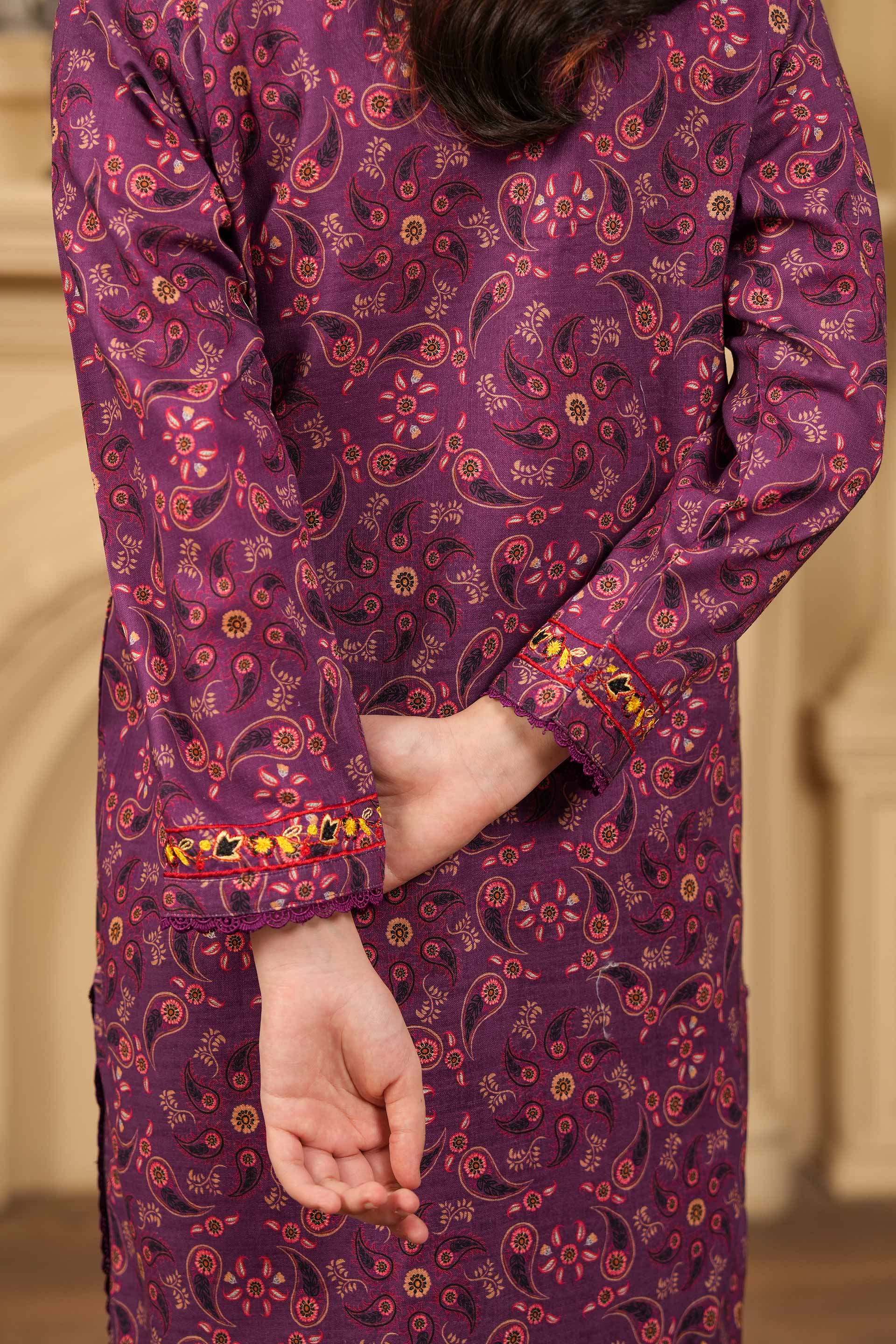 Purple patterned outfit with long sleeves and a blurred background